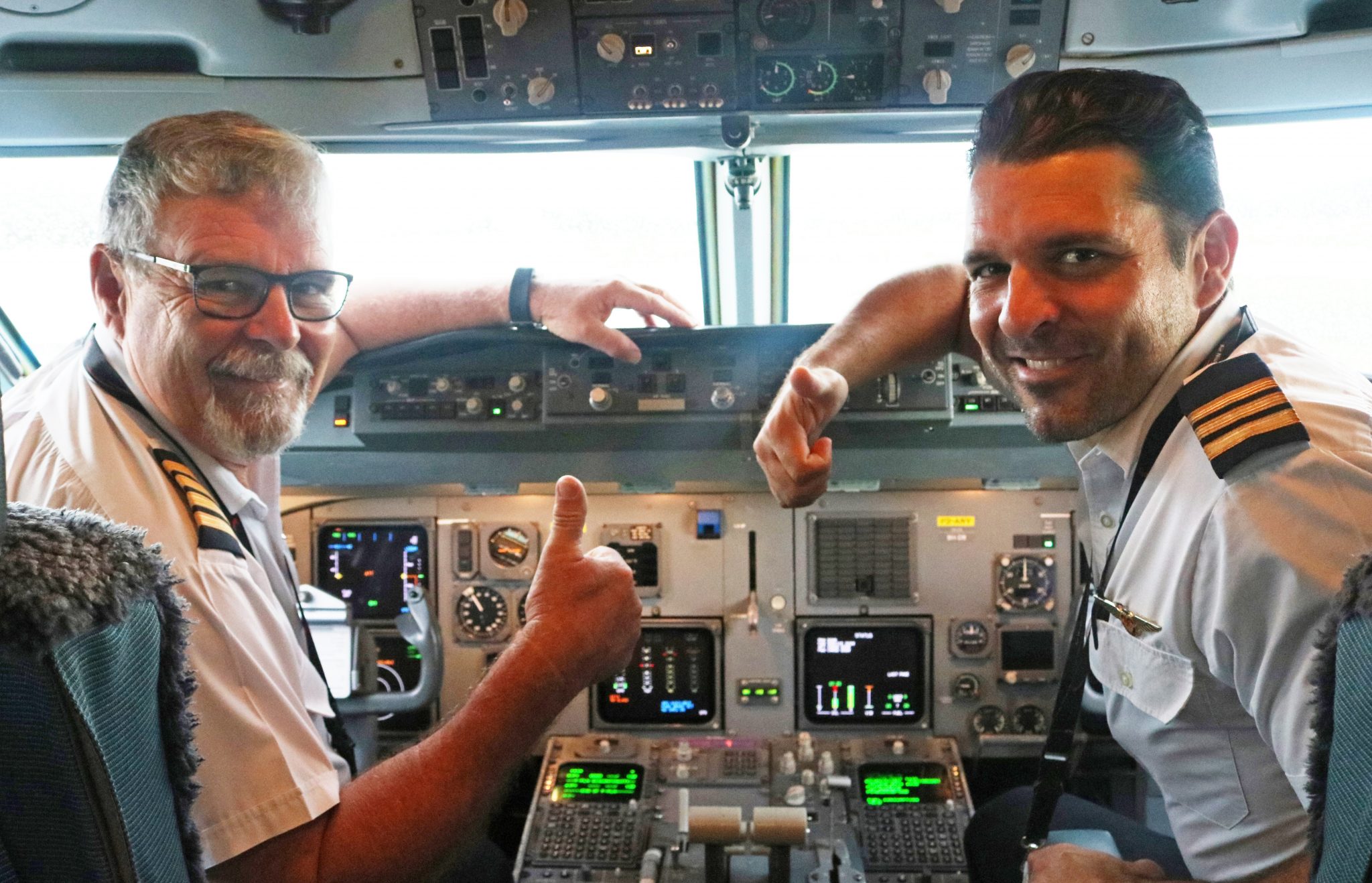 Captain Mark Yates Round and First Officer Christian Yates Roundright in the flight deck of PX 208 prior to operating their first flight together as father and son - Air Niugini