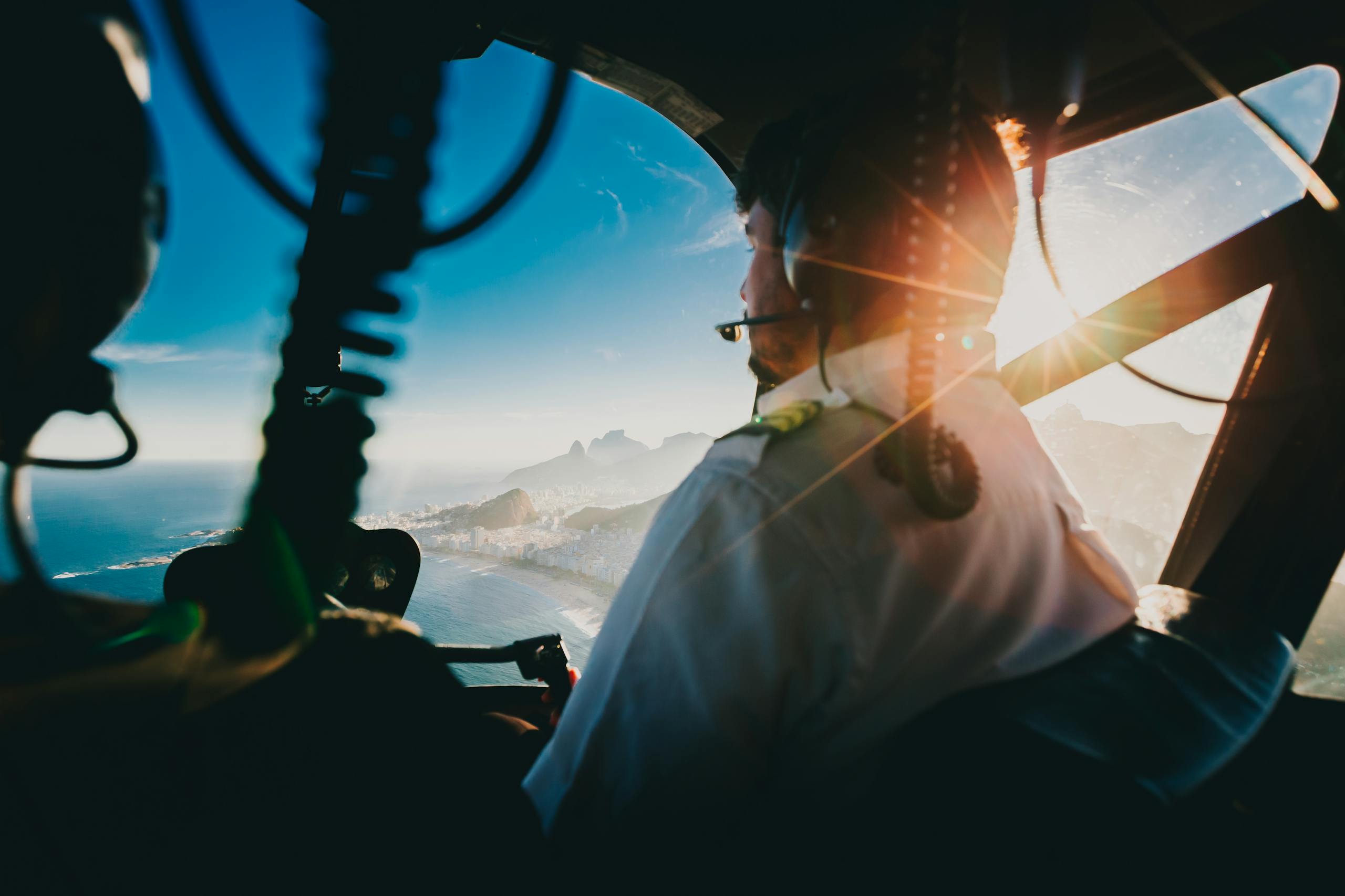 Flying over Rio de Janeiro, a helicopter pilot navigates at sunset with stunning views.